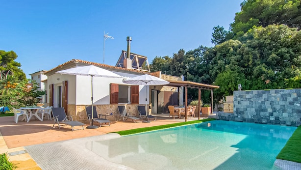 A house with a swimming pool, outdoor furniture, and a pergola. - Gorgeous home in Canyamel with private swimming pool, can be inside or outside (Canyamel)