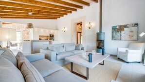 A modern living room with a sofa, a coffee table, and a fireplace.