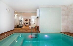 A swimming pool with a wooden deck, a treadmill, and a dartboard in the background. - Awesome home in Portocolom with private swimming pool, can be inside or outside (Portocolom)