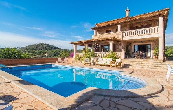 A poolside area with a stone pool, outdoor seating, and a view of a hillside. - Awesome home in SHorta with private swimming pool, can be inside or outside (SHorta)
