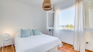 A bedroom with a bed, a window with a view, and a hanging light fixture. - Awesome home in Son Serra de Marina with WiFi (Son Serra de Marina)