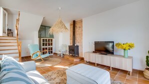 A living room with a sofa, TV, and a fireplace. - Awesome home in Son Serra de Marina with WiFi (Son Serra de Marina)