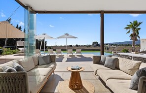 A modern outdoor living area with a pool, lounge chairs, and a sofa set. - Cozy home in Costitx with private swimming pool, can be inside or outside (Costitx)