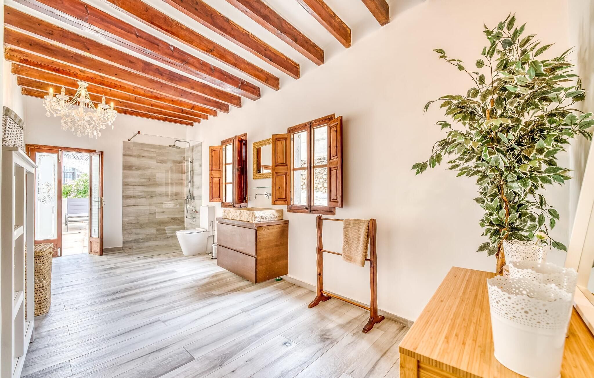 A spacious bathroom with a shower, a sink, and a mirror.