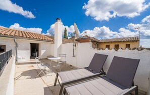A rooftop terrace with two lounge chairs, a small table, and a satellite dish. - Cozy home in Arta with private swimming pool, can be inside or outside (Arta)