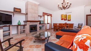 A living room with a fireplace, television, and seating area. - Lovely home in Binissalem with private swimming pool, can be inside or outside (Binissalem)