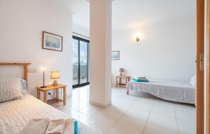 A hotel room with two beds, a window, and a door. - Gorgeous apartment in Port de Pollenca with WiFi (Port de Pollenca)