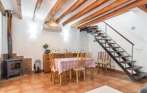 A dining area with a table set for four, a wooden staircase, and a fireplace. - 3 bedroom gorgeous apartment in Soller (Soller)