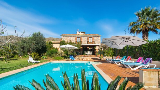 A pool area with a pool, lounge chairs, and umbrellas. - Beautiful home in Pollenca with private swimming pool, can be inside or outside (Pollenca)