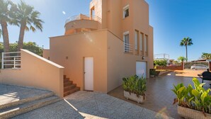 A modern building with a flat roof, a small balcony, and a staircase leading to the entrance. - Amazing home in Sa Coma with private swimming pool, can be inside or outside (Sa Coma)