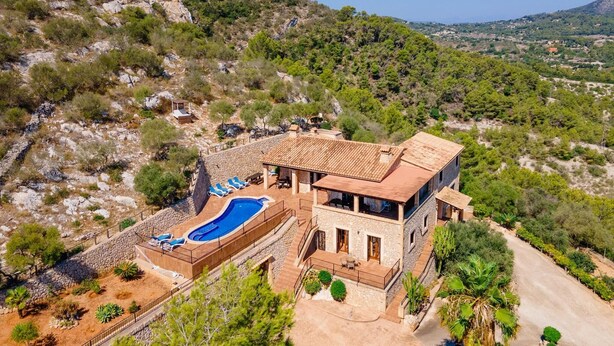 A two-story stone house with a swimming pool, surrounded by a landscaped garden and a mountainous backdrop. - Nice home in Son Macia with private swimming pool, can be inside or outside (Son Macia)