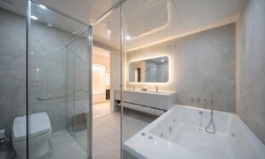 A modern bathroom with a glass shower enclosure, a large bathtub, and a vanity with a mirror. - Daegu Hyeonpung Prana Hotel (Daegu)
