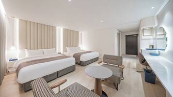 A modern hotel room with two beds, a desk, a chair, and a small table.