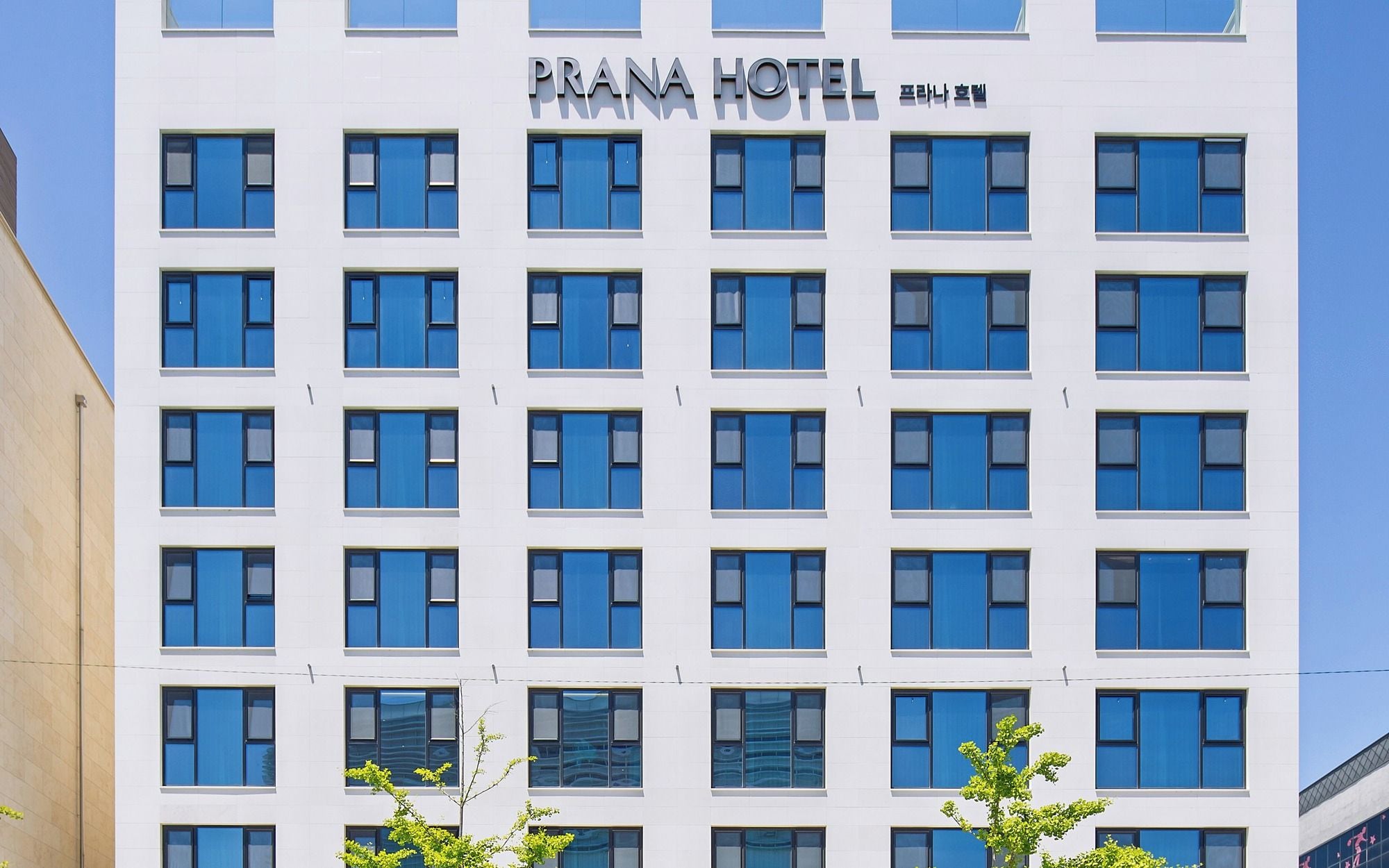 A multi-story building with a sign reading 'PRANA HOTEL' and Korean characters.