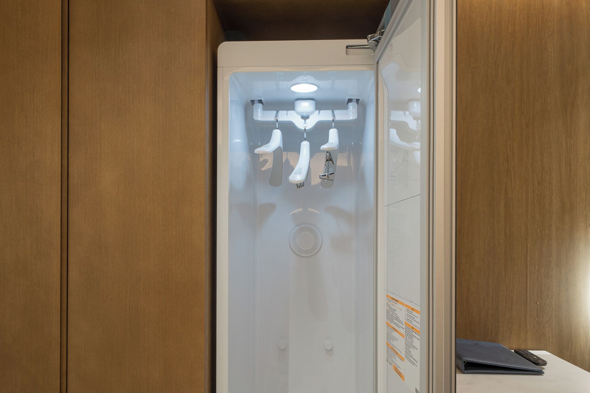 A bathroom with a glass partition, a white toilet, and a mirror.