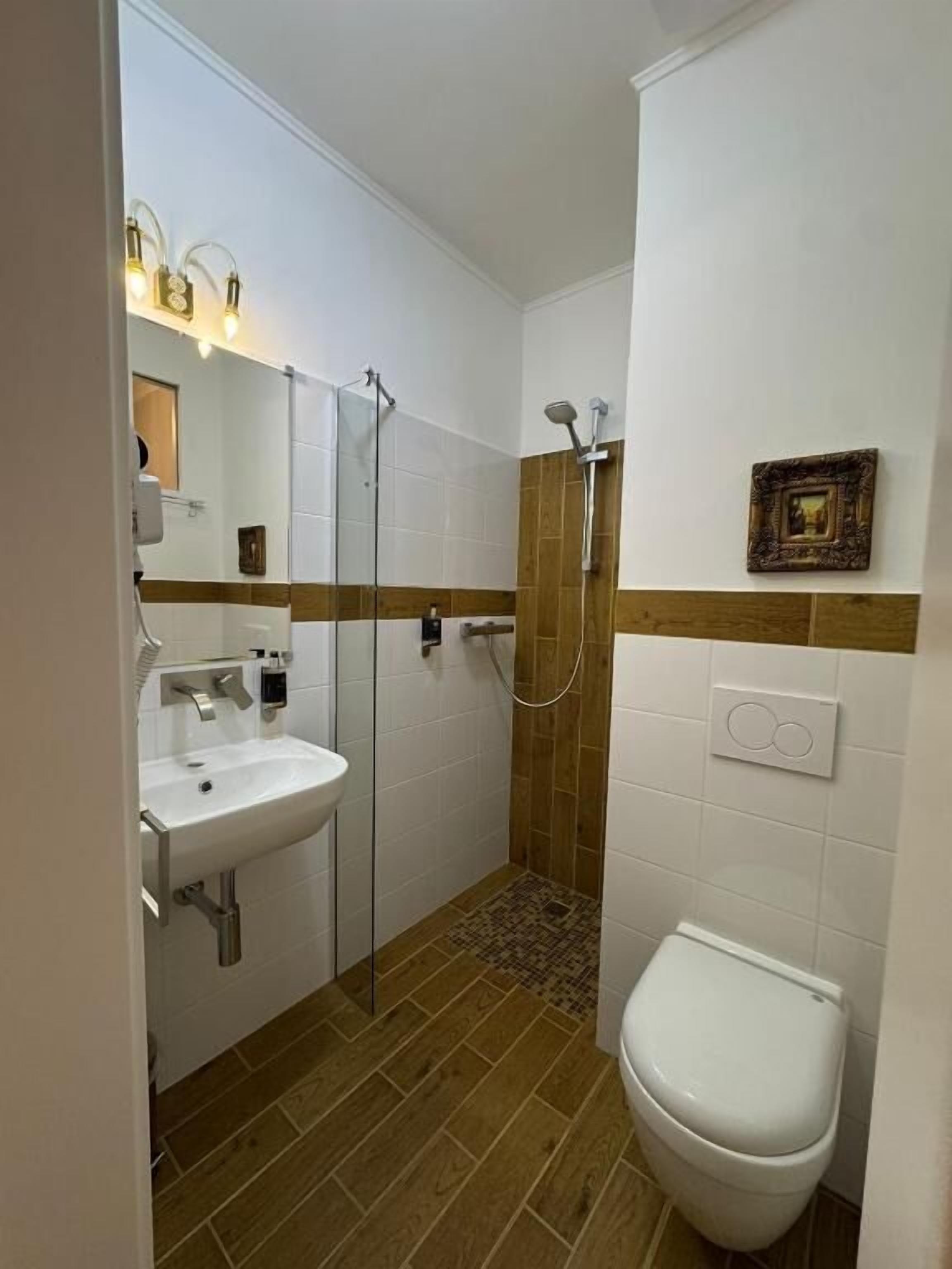 Un baño con ducha, lavabo e inodoro.