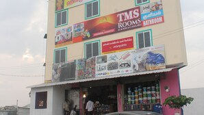 A building with multiple signs advertising rooms and bathroom services. - TMS Residency (Tiruvannamalai)