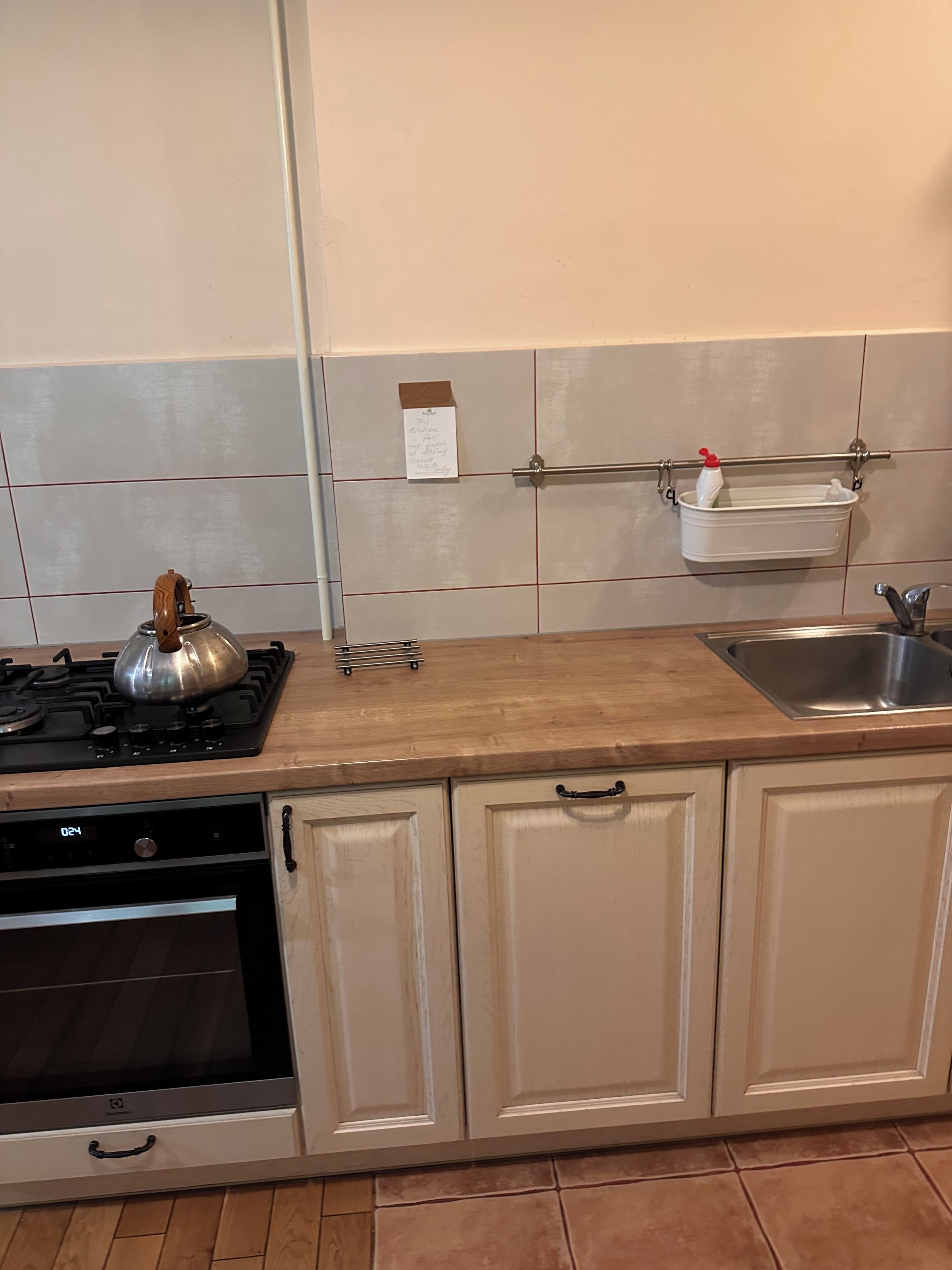 A kitchen with a stove, oven, and a sink.