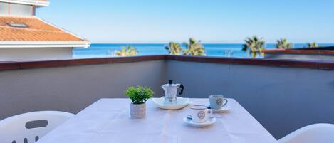 Panoramic Apartment, Balcony, Ocean View | Outdoor dining