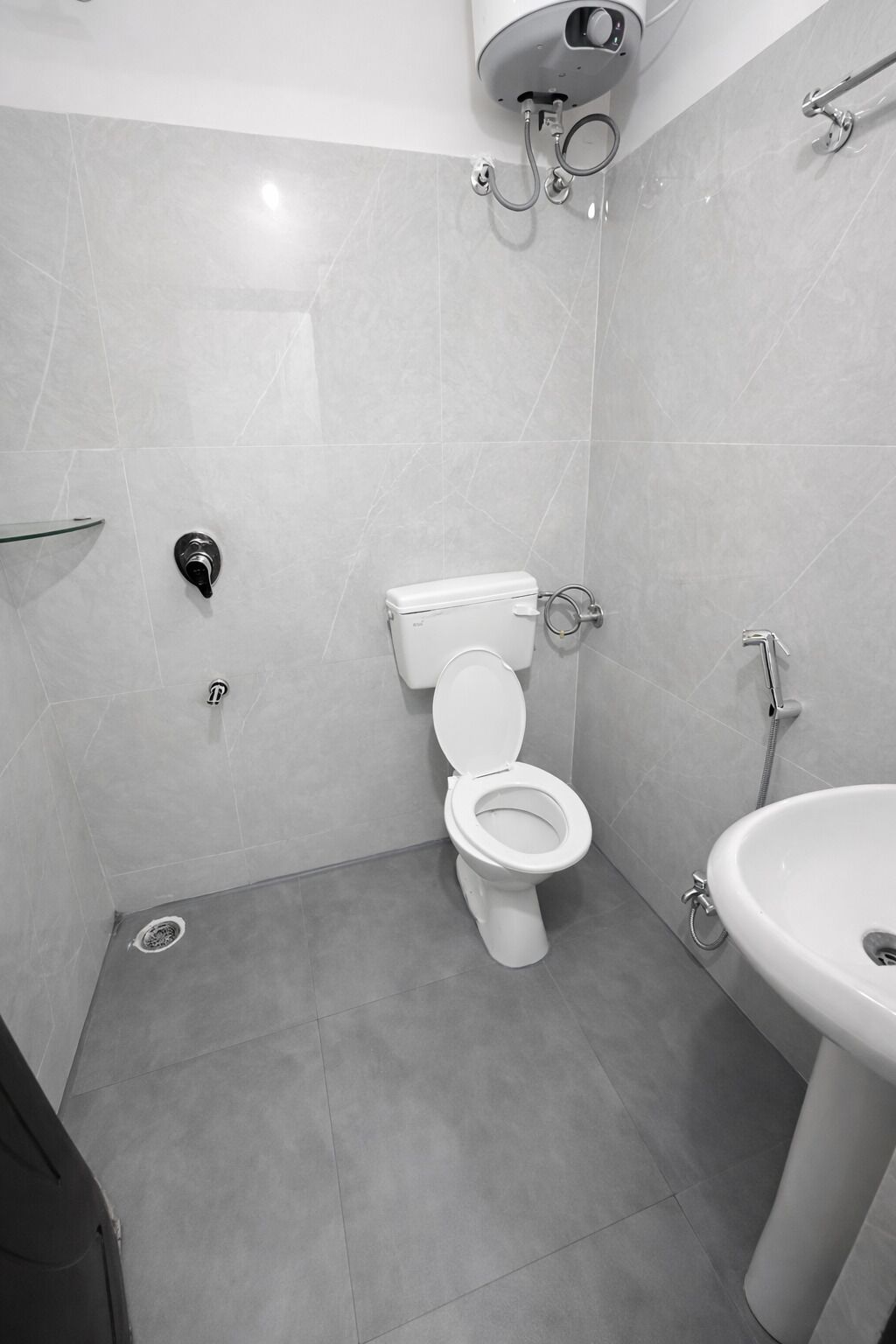 A modern bathroom with a toilet, bidet, and sink.