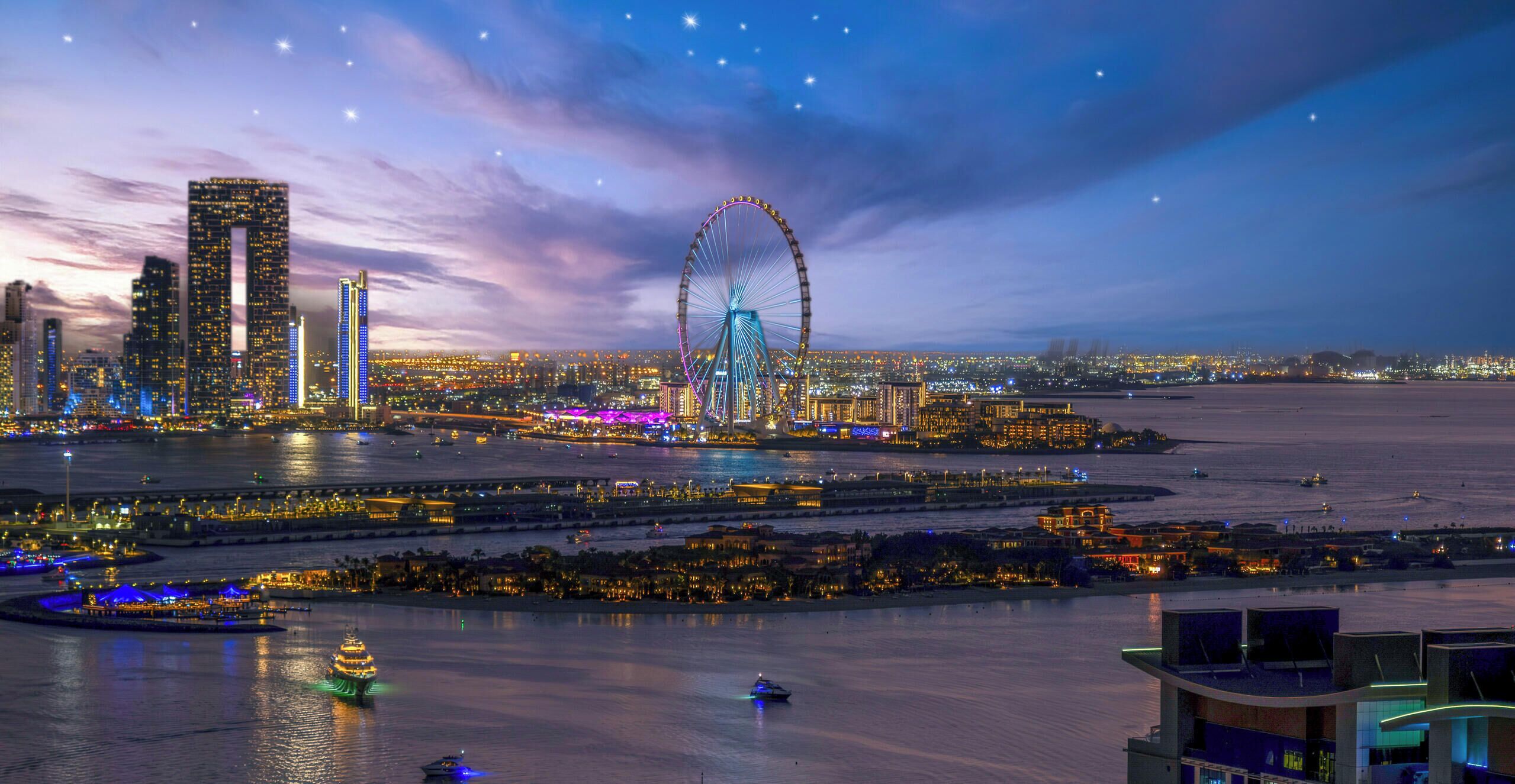 A cityscape at dusk with illuminated skyscrapers, a prominent Ferris wheel, and a waterfront area with boats.