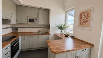 Luxury Suite, City View | Private kitchen | Mini-fridge, microwave, oven, stovetop