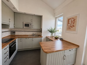 Luxury Suite, City View | Private kitchen | Mini-fridge, microwave, oven, stovetop