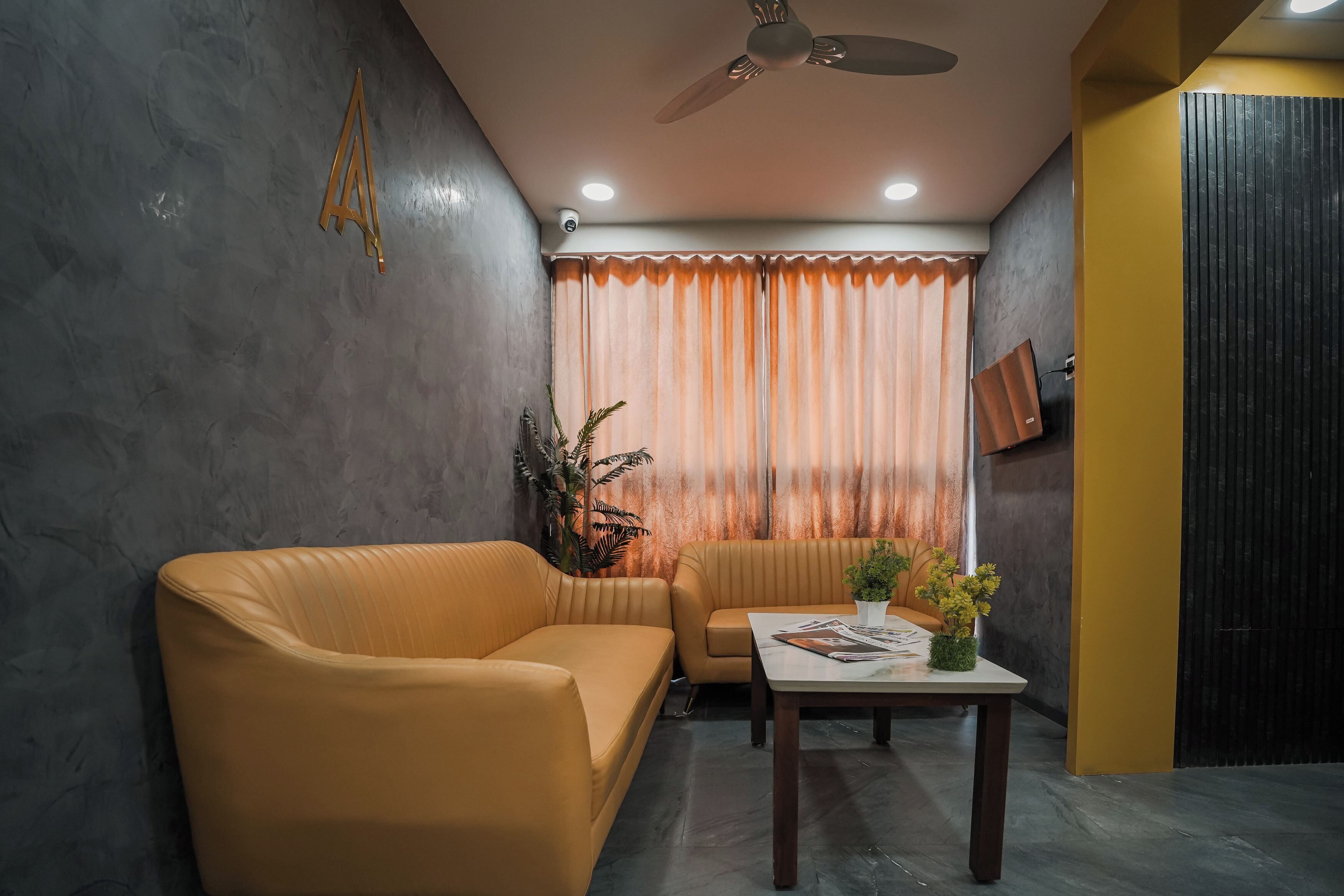 A room with a sofa, a table with magazines, a ceiling fan, and a window with curtains.