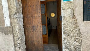 A rustic stone building with a wooden door and a sign indicating ETV Can Miguel. - Can Miguel (Sineu)