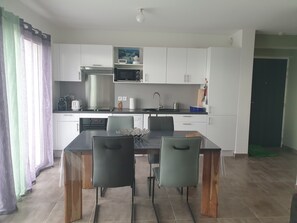 A modern kitchen with white cabinets, a microwave, a toaster, and a sink. - Évasion vue mer à Farinole - 15 m² terrace, 2 minutes from the beach (Farinole)