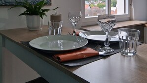 A dining area with a view of a mountainous landscape through a window.