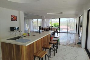 Eine moderne Küche mit einer Holztresen, einem Spülbecken und einem Fernseher.