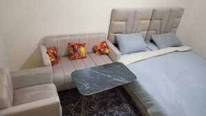 A bedroom with a bed, a sofa, and a small table. - Clean & Cozy Room in Aïn Chock, Casa Nearshore casablanca (casablanca)