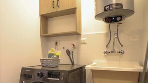 A laundry area with a washing machine, a sink, and a water heater. - w Marvelous 2BR With Balcony in Miraflores (Lima)