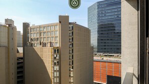 A high-rise building with a modern architectural design, featuring a grid of windows and a flat roof. - Cozy 1BR Condo With City Sky View Downtown (Mexico City)