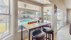A spacious kitchen with large windows, a dining area, and a view of a backyard with a pool. - Private Pool, Yard & Pool Table! 'avondale Abode' (Avondale)