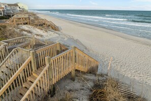 A beach with wooden boardwalks leading to a sandy shore. - Walk to Beach! Spacious 10-person Gem in Surf City (Holly Ridge)