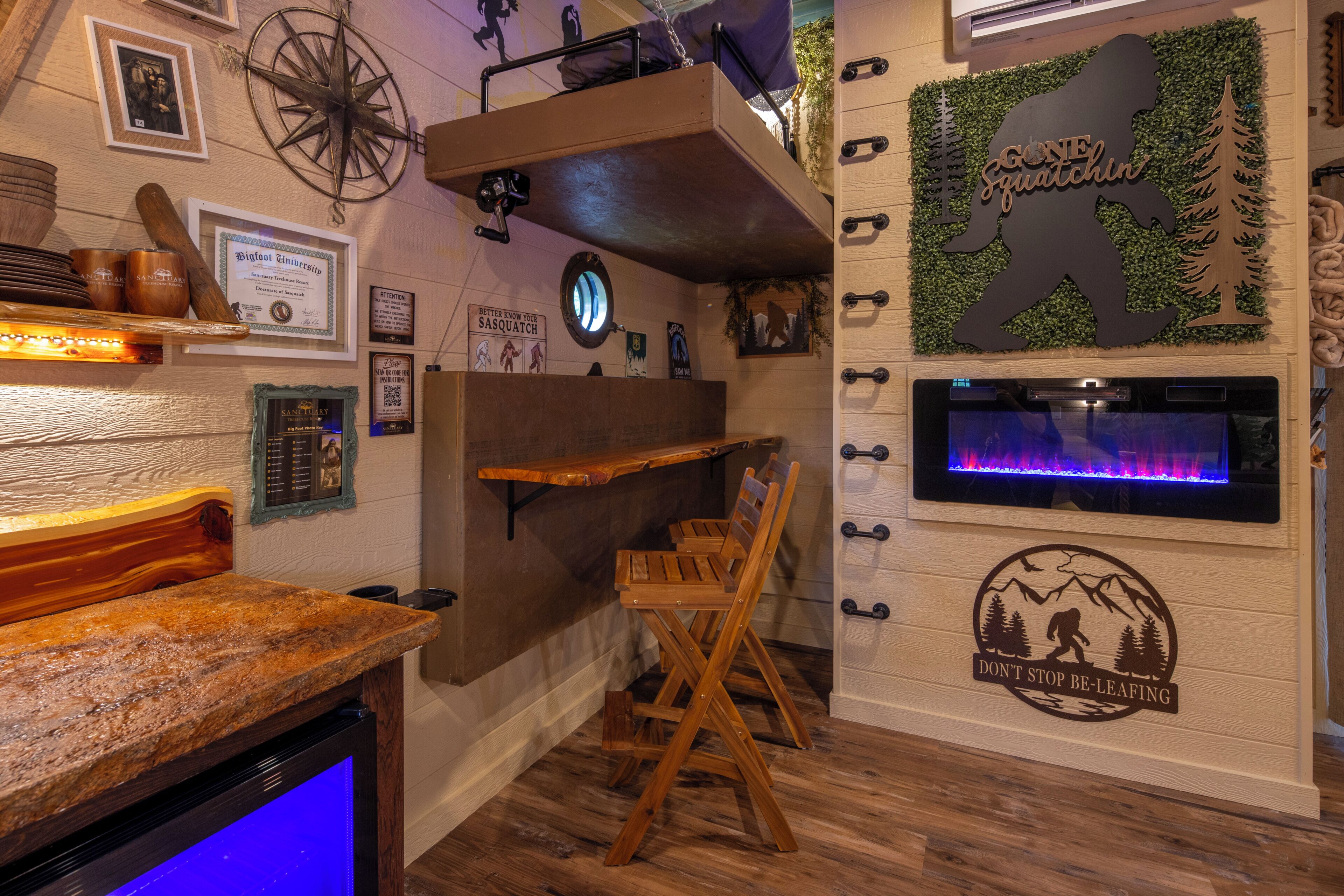 A rustic interior with a wooden bench, a wall-mounted shelf with mugs, a certificate, and a wall clock.