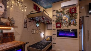 A cozy room with a bunk bed, a small desk, a fireplace, and wall decorations. - 63-OWL ALWAYS LOVE YOU (Sevierville)