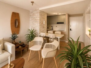 A modern living room with a sofa, two chairs, a coffee table, and a decorative wall piece.