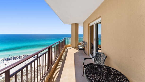 A balcony with a view of the beach and ocean. - 3BR Beachfront Resort Condo - Wraparound Balcony, Pool, Hot Tub, Tram, Beach. (Miramar Beach)
