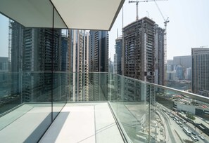 A high-rise building with a glass balcony overlooking a cityscape. - Experience 2BR Luxury Living at in LIV Marina (Dubai)