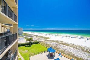 A high-rise hotel overlooking a beach with a clear view of the ocean and sandy shore. - Phoenix V by Brett/Robinson Vacations (Orange Beach)