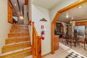 A wooden staircase leading to a landing with a fire extinguisher mounted on the wall. - The Blue Bear Cabin  3 Bedrooms, Hot Tub, (South Lake Tahoe)