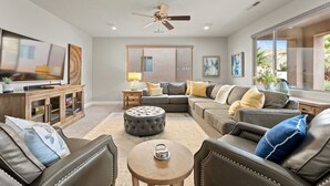 A spacious living room with a sectional sofa, a coffee table, and a ceiling fan. - Paradise Views #93: Private Hot Tub (Santa Clara)