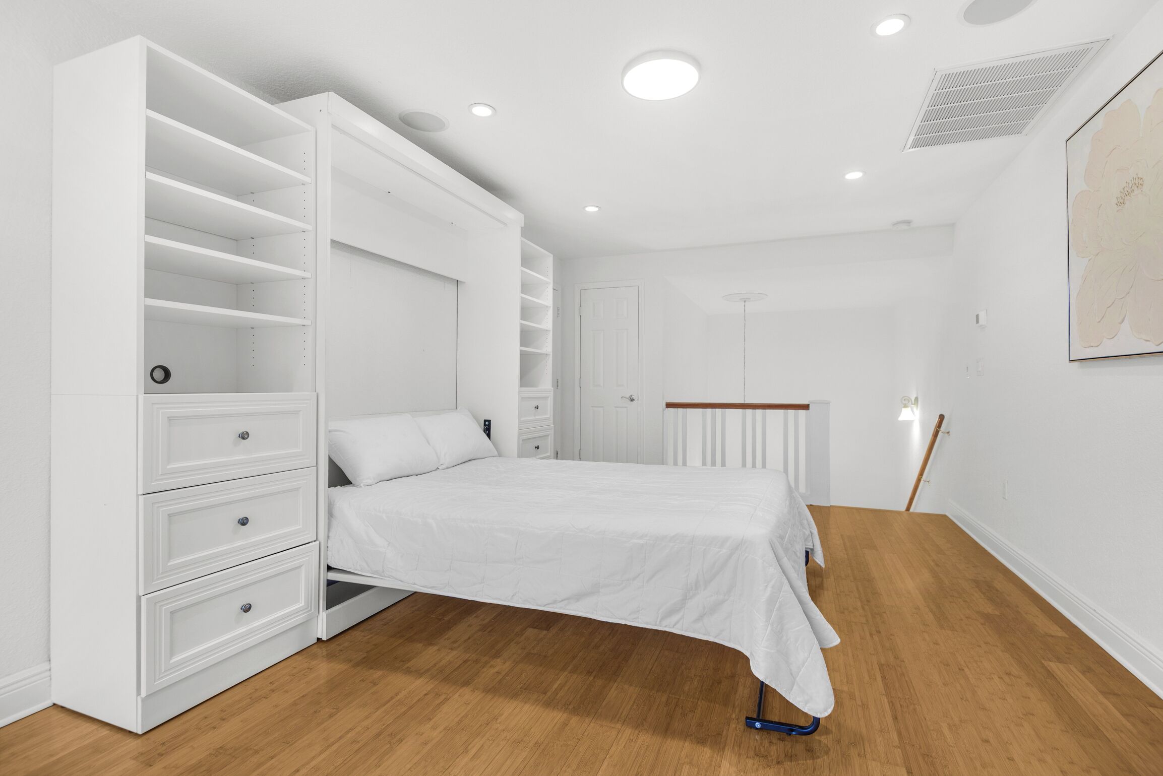 A bedroom with a bed, white wardrobe, and a radiator.