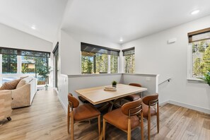 Gather around your bright dining table surrounded by windows that frame peaceful forest views, creating the perfect spot for memorable meals. - Serene Luxury Stay Near Keystone Gondola (Keystone)