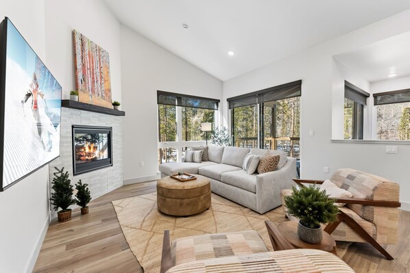 Unwind in your bright living space with cozy fireplace, plush seating, and forest views streaming through panoramic windows. - Serene Luxury Stay Near Keystone Gondola (Keystone)