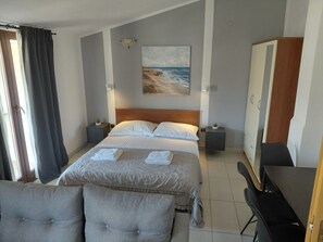 A hotel room with a bed, bedside tables, a desk, a chair, a wardrobe, and a painting on the wall. -  Apartment A2+1 in delightful Grebaštica with AC comfort (Grebaštica)