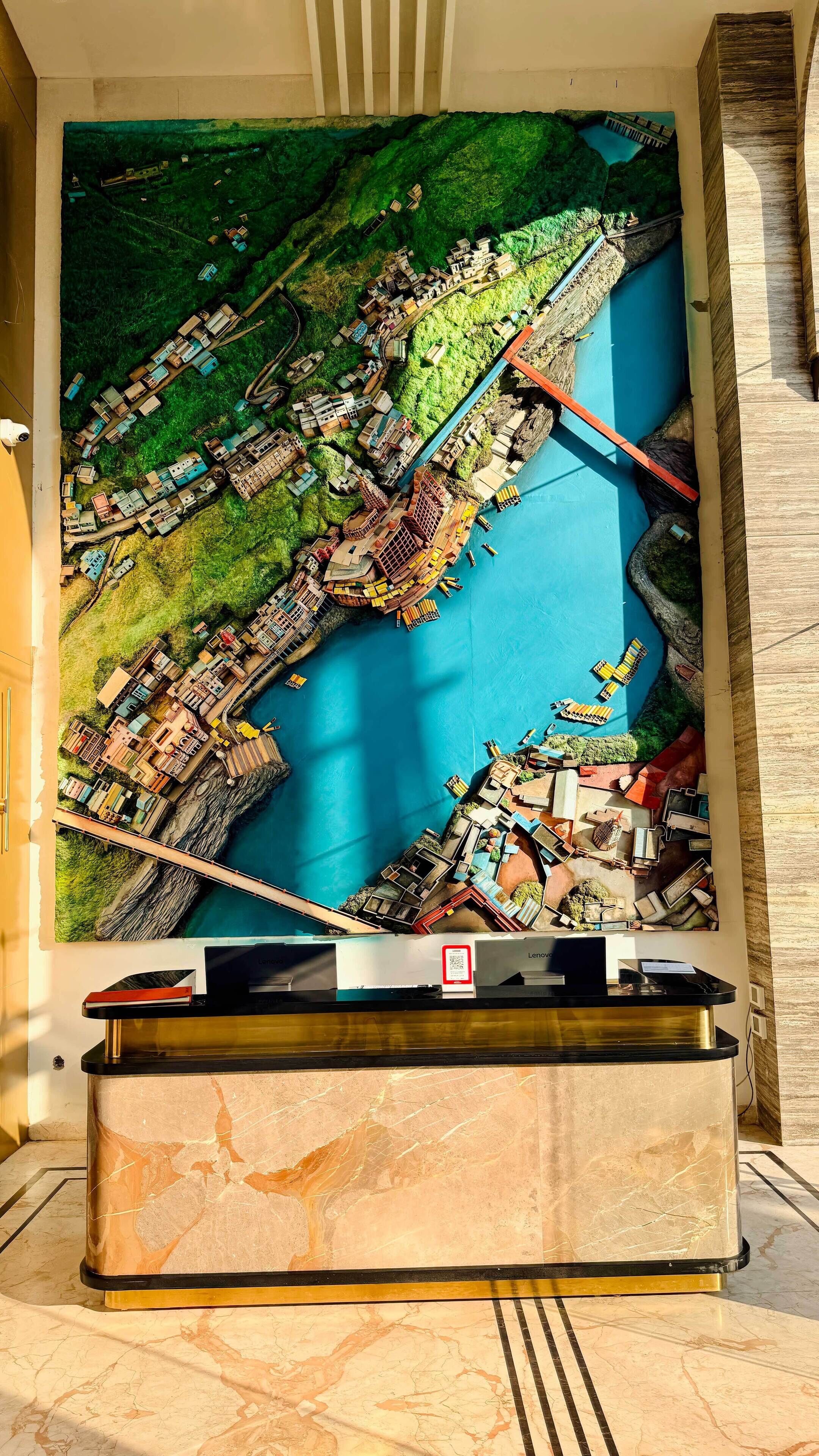 A detailed model of a coastal town with a bridge, docks, and various buildings.